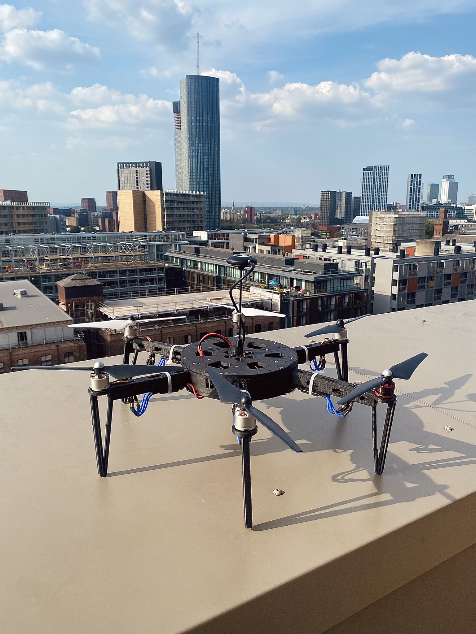 Aeroknite drone on rooftop with Manchester skyline